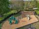 Community playground with swings, slides, and climbing structures in a fenced area at 5430 Crabtree Park Ct, Raleigh, NC 27612