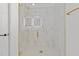 Modern shower features gold hardware, glass doors, tiled walls, a tiled shower floor, and a rain shower head at 5430 Crabtree Park Ct, Raleigh, NC 27612