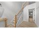 Staircase features wood steps and a wood banister with black balusters at 5430 Crabtree Park Ct, Raleigh, NC 27612