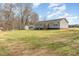 Backyard featuring a well-maintained lawn, a shed, and the rear of the home at 5570 Normans Rd, Rougemont, NC 27572