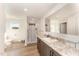 Bright bathroom with a large mirror, vanity, and walk-in shower with patterned curtain at 5570 Normans Rd, Rougemont, NC 27572