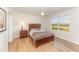 Cozy bedroom with a wooden bed frame, neutral walls, and a bright window view at 5570 Normans Rd, Rougemont, NC 27572