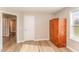Small bedroom with a cedar wardrobe and a bright window at 5570 Normans Rd, Rougemont, NC 27572