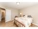 Cozy bedroom with light wood floors, neutral paint, and a comfy floral bedspread at 5570 Normans Rd, Rougemont, NC 27572
