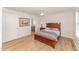 Neutral bedroom with dark wood bed frame, ceiling fan, and a connecting bath at 5570 Normans Rd, Rougemont, NC 27572