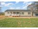 Charming single-story home with a covered front porch, green siding, black shutters, and well-maintained lawn at 5570 Normans Rd, Rougemont, NC 27572