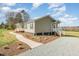 Charming home exterior with landscaped grounds and a winding sidewalk and a gravel driveway at 5570 Normans Rd, Rougemont, NC 27572