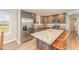 Modern kitchen featuring stainless steel appliances, custom cabinets, granite counters, and a large island with seating at 5570 Normans Rd, Rougemont, NC 27572