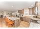 Bright, open kitchen with stainless steel appliances, an island, and wood-look floors at 5570 Normans Rd, Rougemont, NC 27572