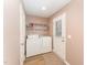 Functional laundry room with washer, dryer, and a back door for easy access to the outside at 5570 Normans Rd, Rougemont, NC 27572