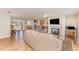 Open-concept living room features a cozy fireplace, hardwood floors, and seamless connection to the kitchen and dining area at 5570 Normans Rd, Rougemont, NC 27572