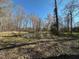 Beautiful pond surrounded by trees and foliage, creating a serene natural setting at 5570 Normans Rd, Rougemont, NC 27572