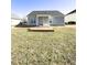 View of home's backyard featuring a partially covered patio area and spacious grassy lawn at 6320 Slopeside Ct, Raleigh, NC 27610