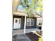 Charming front porch featuring stone accents, white columns, and a welcoming entrance with a decorative wreath at 6320 Slopeside Ct, Raleigh, NC 27610