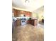 Modern kitchen with stainless steel appliances, wooden cabinets, and tile flooring, perfect for cooking and dining at 6320 Slopeside Ct, Raleigh, NC 27610