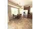 Eat-in kitchen features stainless fridge, a table for four, and natural light at 6320 Slopeside Ct, Raleigh, NC 27610