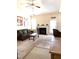 Cozy living room with a ceiling fan, fireplace, and comfortable furnishings, creating an inviting atmosphere at 6320 Slopeside Ct, Raleigh, NC 27610
