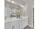 Bright bathroom featuring double sinks, stylish cabinetry, and a large framed mirror at 706 Fireball Ct, Knightdale, NC 27545