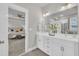 Bathroom leading into the main bedroom featuring a double sink vanity and large mirror at 706 Fireball Ct, Knightdale, NC 27545
