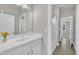 Well-lit bathroom featuring a spacious vanity, modern fixtures, and a view to the entryway at 706 Fireball Ct, Knightdale, NC 27545