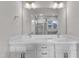 Double sink bathroom vanity with storage underneath and a large mirror framed by modern sconces at 706 Fireball Ct, Knightdale, NC 27545