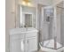 Bathroom with modern glass shower, stylish vanity, and neutral tile at 706 Fireball Ct, Knightdale, NC 27545