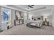 Bright and airy main bedroom featuring a tray ceiling, carpeted floors, and stylish decor at 706 Fireball Ct, Knightdale, NC 27545