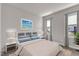 Bright bedroom featuring neutral walls, two windows, and a comfortable bed with stylish throw pillows at 706 Fireball Ct, Knightdale, NC 27545