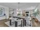Spacious dining area adjacent to a living room featuring a fireplace, comfortable seating, and natural light at 706 Fireball Ct, Knightdale, NC 27545
