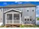Rear exterior view featuring a screened in porch and gray siding at 706 Fireball Ct, Knightdale, NC 27545