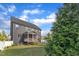 Back exterior view of the home highlighting the spacious yard and screened-in porch at 706 Fireball Ct, Knightdale, NC 27545