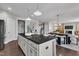An open-concept kitchen boasts an island, sleek countertops, and hardwood floors, perfect for culinary enthusiasts and socializing at 706 Fireball Ct, Knightdale, NC 27545