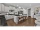 Stylish kitchen with an island, white cabinetry, modern appliances, and hardwood floors; great for entertaining guests at 706 Fireball Ct, Knightdale, NC 27545