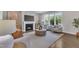 Bright living room with a fireplace, ample natural light, and comfortable seating creates a welcoming atmosphere for relaxation at 706 Fireball Ct, Knightdale, NC 27545