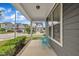 View from the front porch of a gray house showcasing a seating area and neighborhood views at 706 Fireball Ct, Knightdale, NC 27545