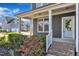Inviting front porch with a brick staircase, pretty landscaping and view of other houses in the neighborhood at 706 Fireball Ct, Knightdale, NC 27545