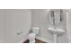 Powder room with pedestal sink and hardwood floors at 706 Fireball Ct, Knightdale, NC 27545