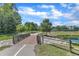 Scenic community walking path leading across a wooden bridge and picturesque pond at 706 Fireball Ct, Knightdale, NC 27545