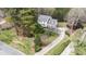 Expansive aerial view of a white home with a long driveway surrounded by lush greenery and trees at 7201 Jonathan Dr, Wendell, NC 27591