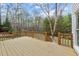 Back deck with wood flooring surrounded by railings overlooking trees in the backyard at 7201 Jonathan Dr, Wendell, NC 27591