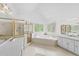 Bright and spacious bathroom featuring a jacuzzi tub, shower, double vanity and natural lighting at 7201 Jonathan Dr, Wendell, NC 27591