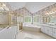 Bathroom with floral wallpaper and tiled flooring featuring a jacuzzi tub, shower, double vanity and natural lighting at 7201 Jonathan Dr, Wendell, NC 27591