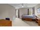 Cozy bedroom with natural light from two windows, wood bed frame, and neutral carpeting at 7201 Jonathan Dr, Wendell, NC 27591