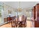 Elegant dining room with floral wallpaper, wood floors, and a vintage chandelier at 7201 Jonathan Dr, Wendell, NC 27591