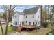 Exterior back elevation showcasing a spacious deck and landscaped backyard with mature trees at 7201 Jonathan Dr, Wendell, NC 27591