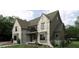 Charming stone and siding home featuring professional landscaping at 7641 Falls Creek Ln, Raleigh, NC 27614