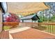 Outdoor back deck with shade cover, overlooking backyard and storage building at 829 Colleton Rd, Raleigh, NC 27610