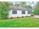 Home's exterior shows a manicured lawn, mulched flower beds, and recently paved driveway at 829 Colleton Rd, Raleigh, NC 27610