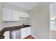 Bright kitchen featuring white cabinets, stainless steel appliances, and granite countertops at 829 Colleton Rd, Raleigh, NC 27610