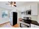 Bright kitchen with stainless steel appliances, ceiling fan, and hardwood floors at 829 Colleton Rd, Raleigh, NC 27610